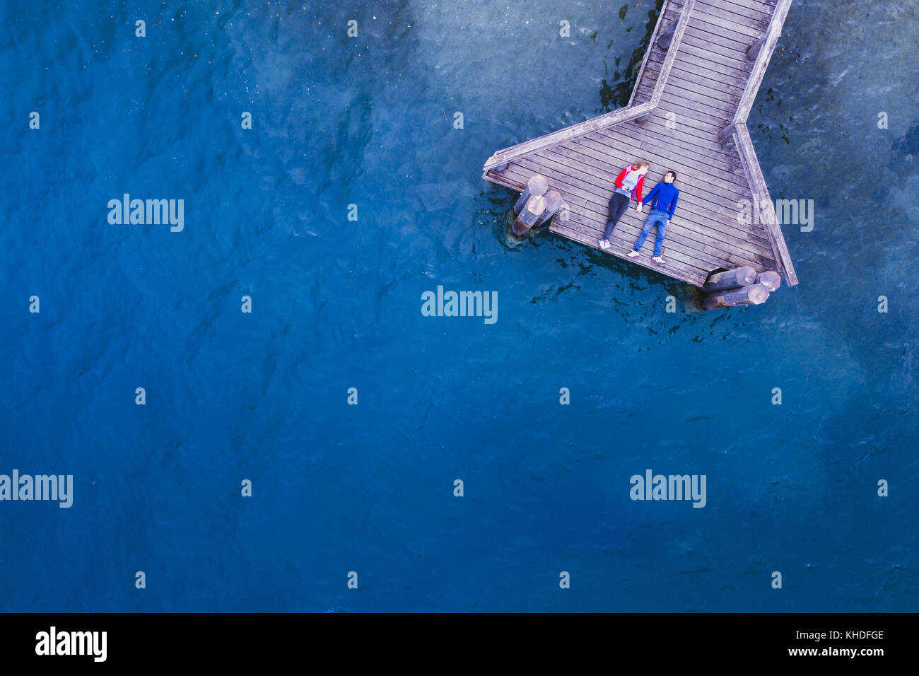 Romantisches Paar liegen auf dem Holzsteg am See mit blauem Wasser, Liebe und dating Konzept, Hintergrund mit Copyspace Stockfoto