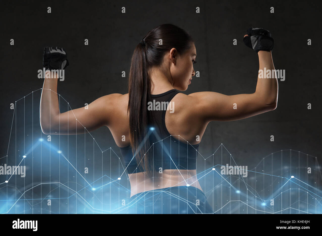junge Frau, die Muskeln im Fitness-Studio Stockfoto