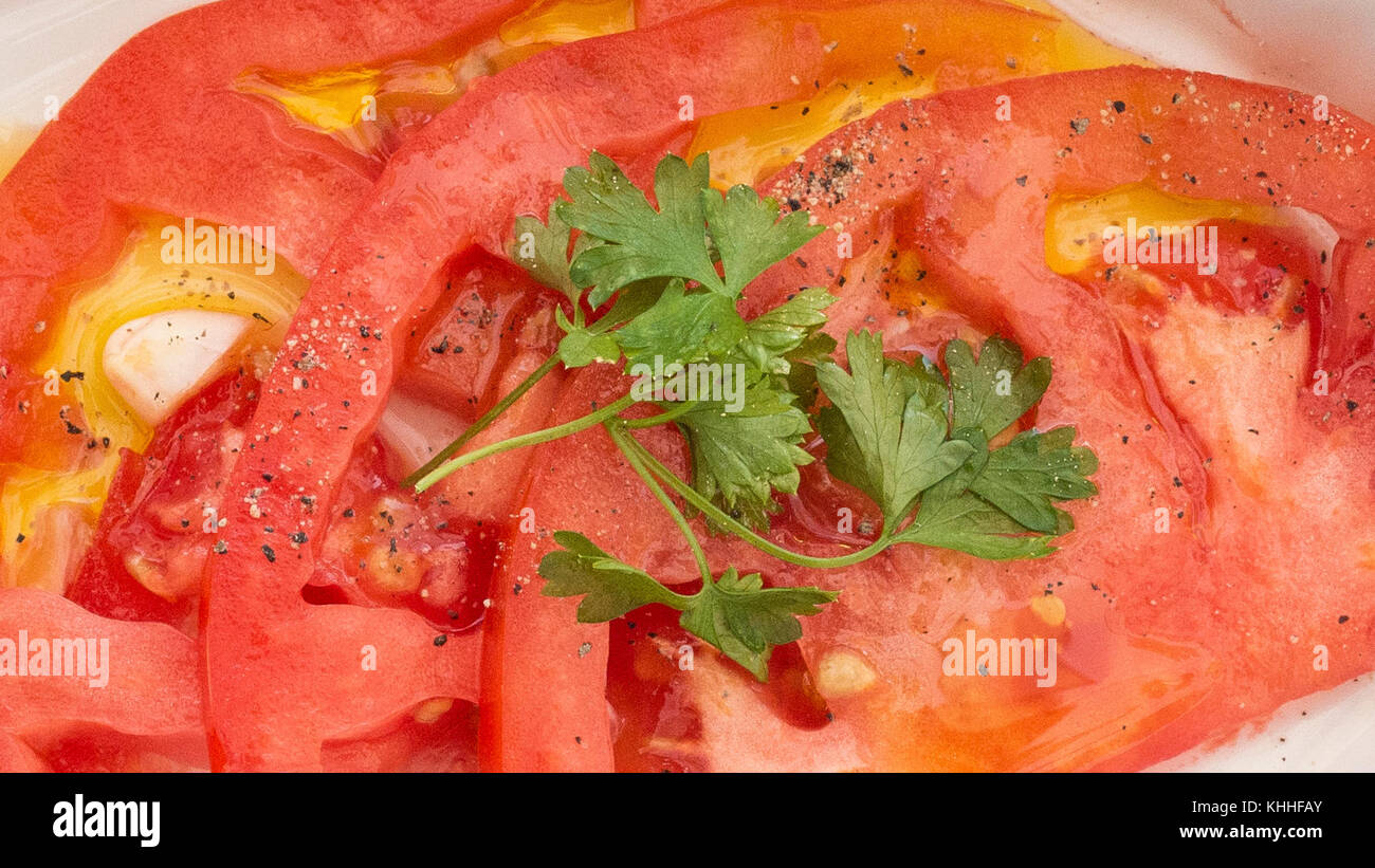 Spanische Tomaten Salat ergibt 4 Portionen Zubereitungszeit: 5 Minuten Garzeit: 0 Minuten Gesamtzeit: 5 Minuten 2 Tomaten 2 Knoblauchzehen 1 El Petersilie 3 El Olivenöl Salz und Pfeffer, zum Abschmecken 1. Tomaten waschen, in Scheiben schneiden und dann halbieren. 2. Knoblauchzehen schälen und fein hacken. 3. Frische Petersilie waschen und hacken. 4. Tomaten auf einen Teller legen und mit Salz, Pfeffer, Olivenöl, Knoblauch und Petersilie anrichten. Kalt servieren und genießen! ------------------------------------------------------------------------------------------------------------------ Stockfoto