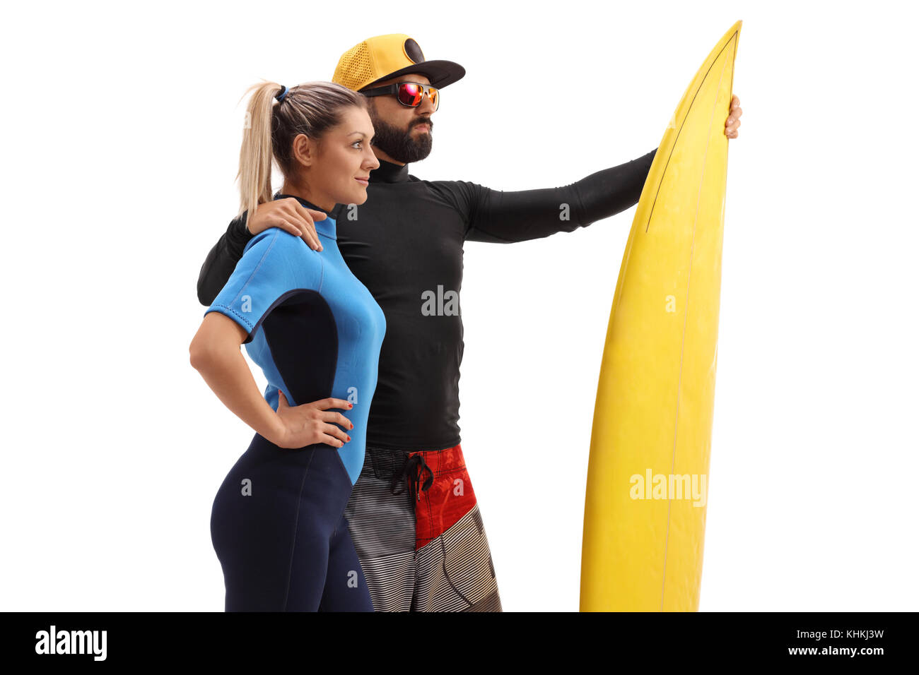 Männliche und eine weibliche Surfer mit einem Surfbrett auf weißem Hintergrund Stockfoto