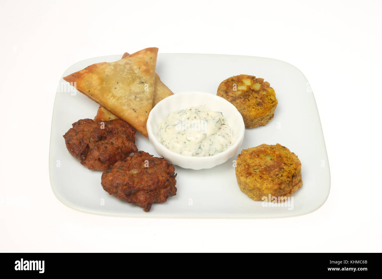 Indische snack Auswahl mit einem Sprung auf eine Platte gegen Weiße isoliert Stockfoto