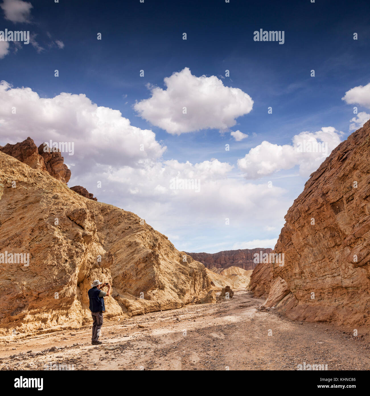 Älterer Mann mit seinem Telefon Fotografien im Golden Canyon, Death Valley, Kalifornien, USA. Stockfoto