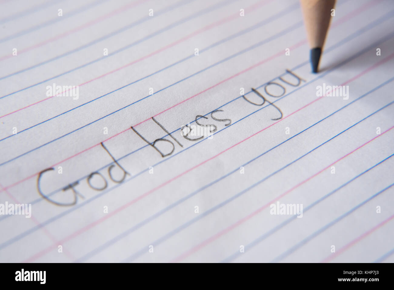 Handschrift mit Bleistift auf Papier. schreiben Sie "Gott segne dich" Stockfoto