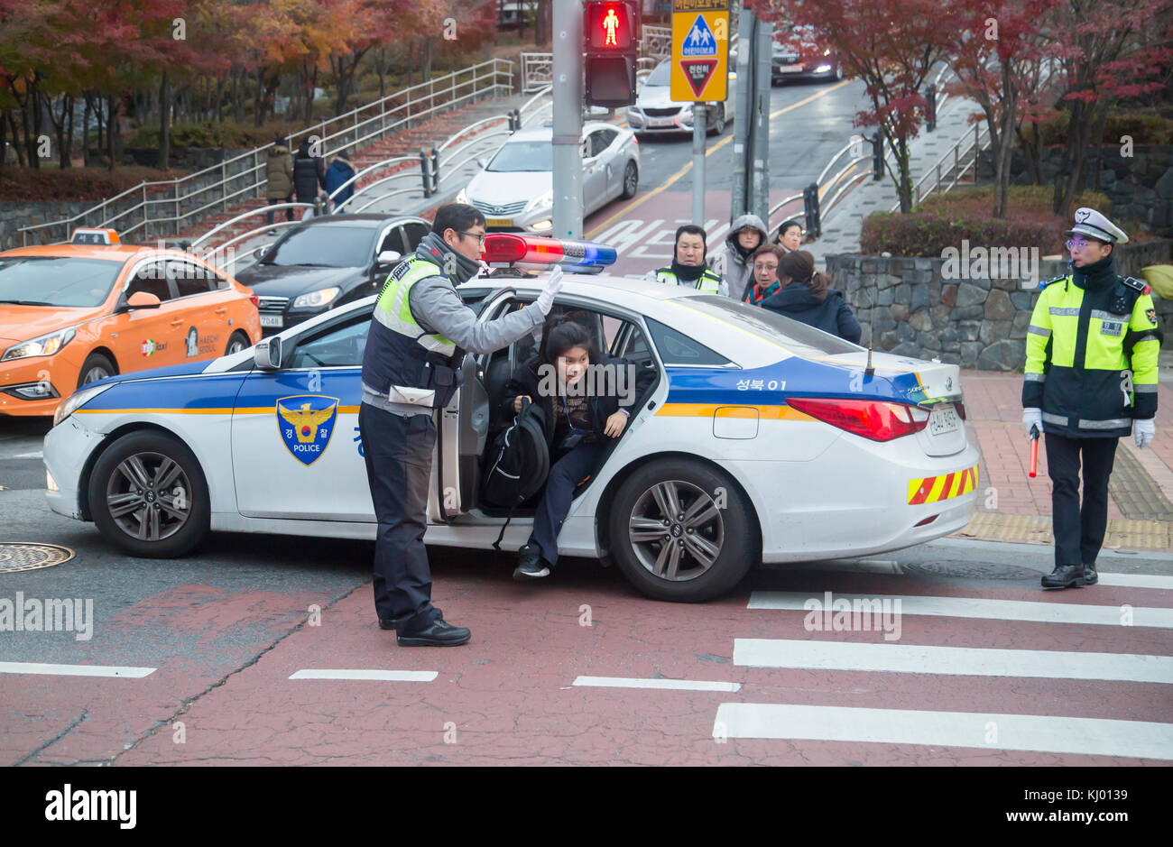 Seoul, Südkorea. 23 Nov, 2017 South Korea Hochschuleingang Prüfung, 23.November 2017: Ein Student wird aus einem Polizei Streifenwagen vor einer Untersuchung Halle nach der Polizei gab ihr eine Fahrt zu machen, pünktlich vor dem College Aufnahmeprüfungen in Seoul, Südkorea. Insgesamt 593,527 Bewerber nehmen Sie die college Scholastic Aptitude Test (CSAT) über dem Land am Donnerstag nach dem staatlich verwaltete Hochschule Aufnahmeprüfung für eine Woche verzögert wurde, nachdem ein Erdbeben im Südosten der Stadt des Landes in pohang auf novemver 15 Hit, lokale Medien berichtet. Credit: Lee Jae-gewonnen/LBA/alamy leben Nachrichten Stockfoto