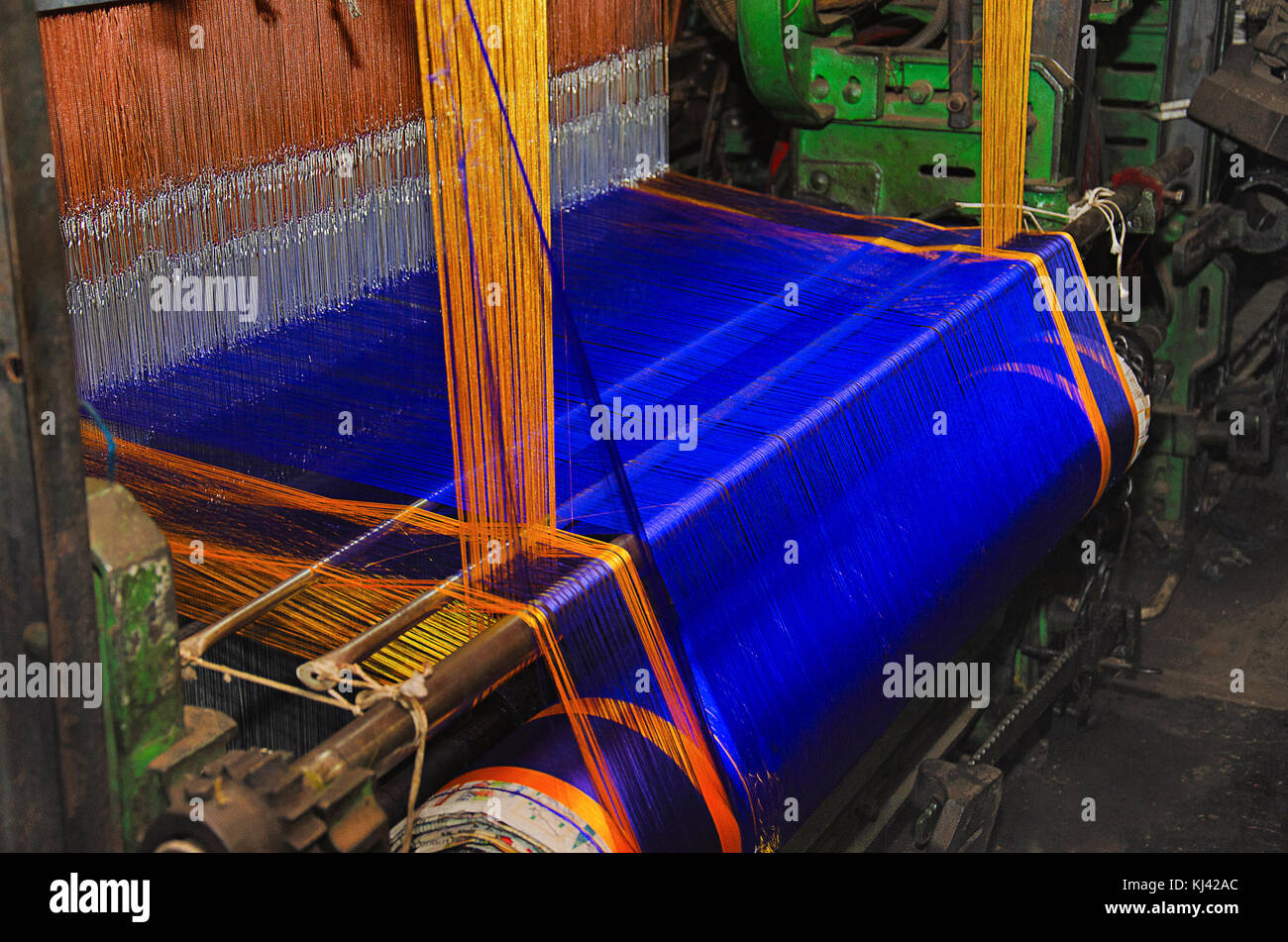 Teil eines automatischen saree Webmaschine in der Weberei 9 Yard blau gefärbten Saree mit goldfarbener Rand eingerückt. Belagavi, Karnataka, Indien Stockfoto