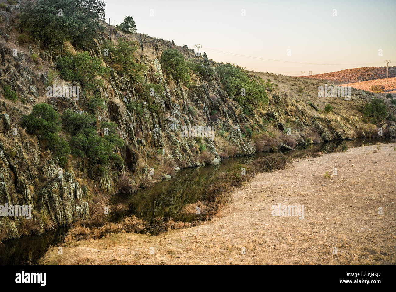 Anochecer sobre un Risco junto a la Rivera del río Guadiloba de Cáceres, Extremadura, Spanien. Stockfoto