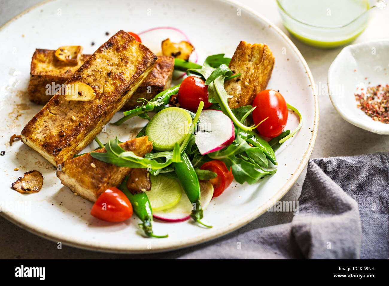 Tofu Steak mit Zuckerschoten und Rucola mit Wasabi creme Dressing Stockfoto