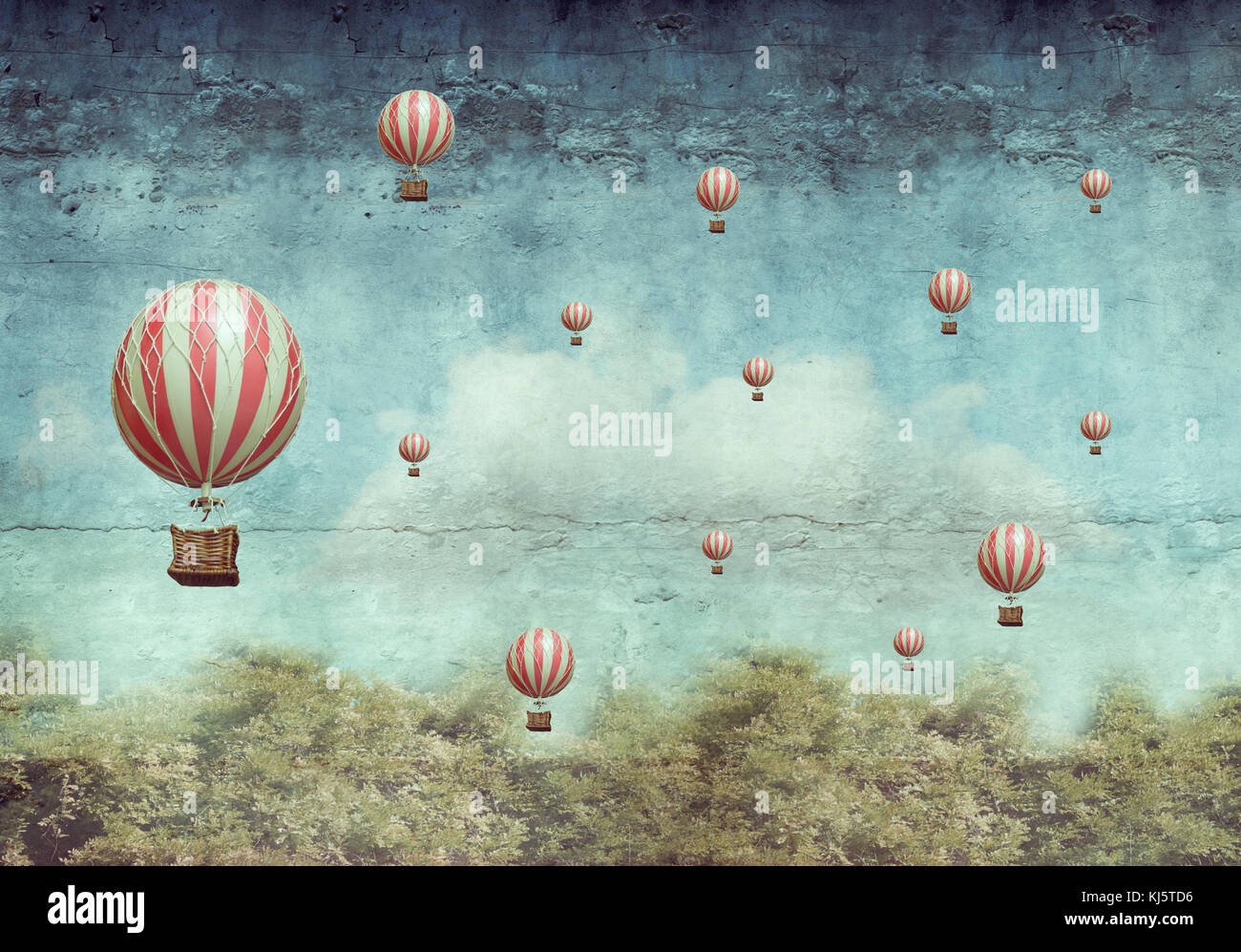 Viele Heißluftballons über einen Wald fliegen Stockfoto