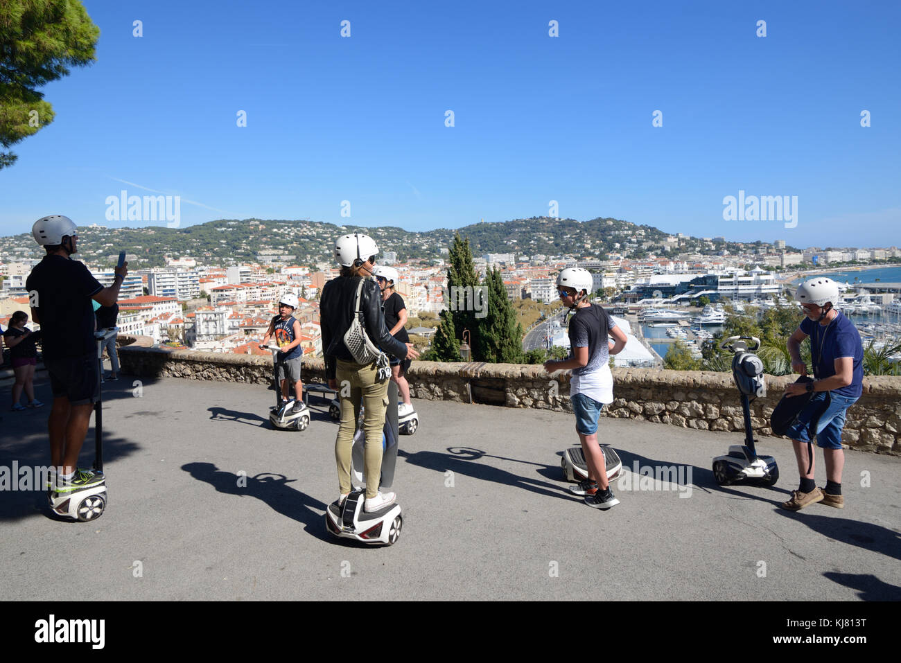 Familien-Touristen auf Segway Scooter Tour in Suquet Altstadt von Cannes mit Blick auf La Croisette Waterfront oder direkt am Meer, Cannes, Französisch Riviera, Frankreich Stockfoto
