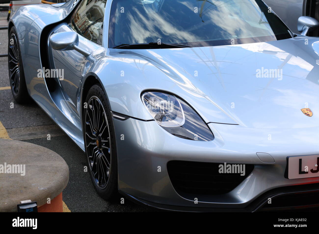 Ein Porsche 918 Spyder in Genua geparkt, vor einer Yacht. Stockfoto