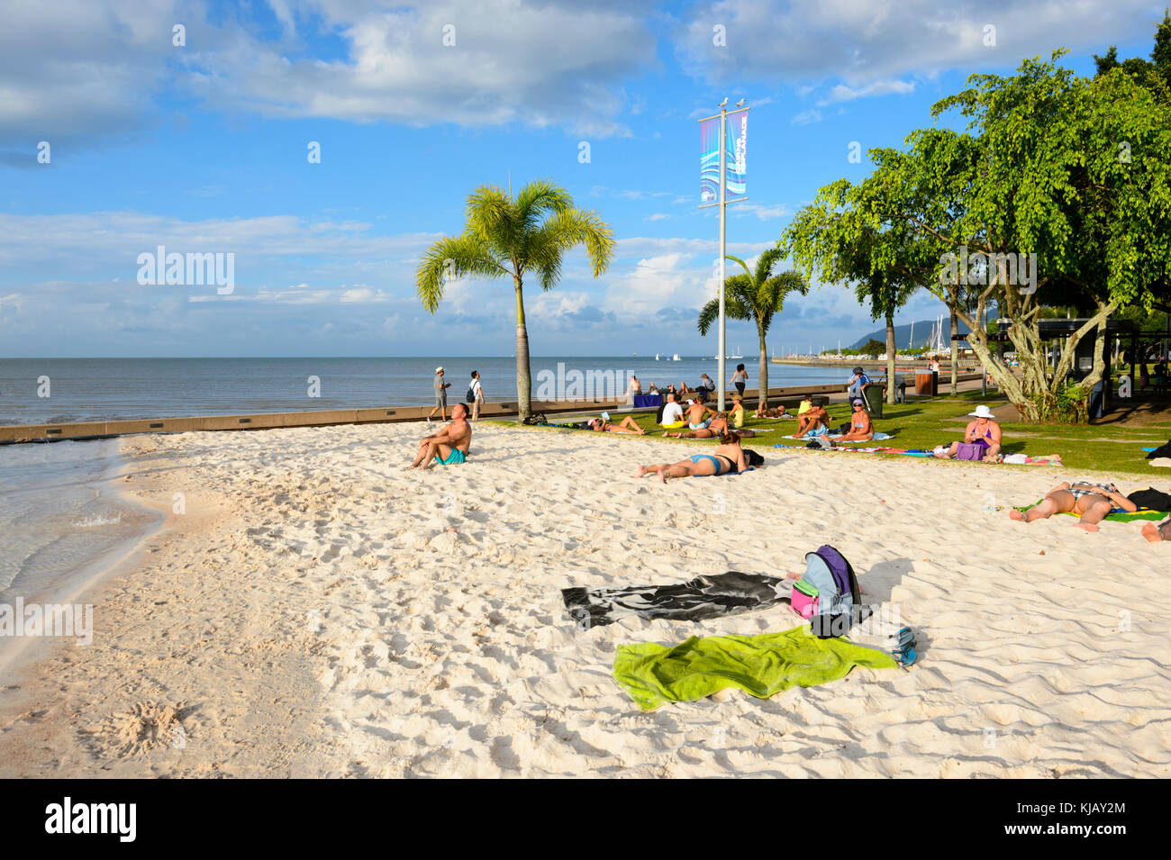 Menschen beim Sonnenbaden auf der künstliche Sandstrand an der Lagune auf der Esplanade, Cairns, Far North Queensland, FNQ, QLD, Australien Stockfoto