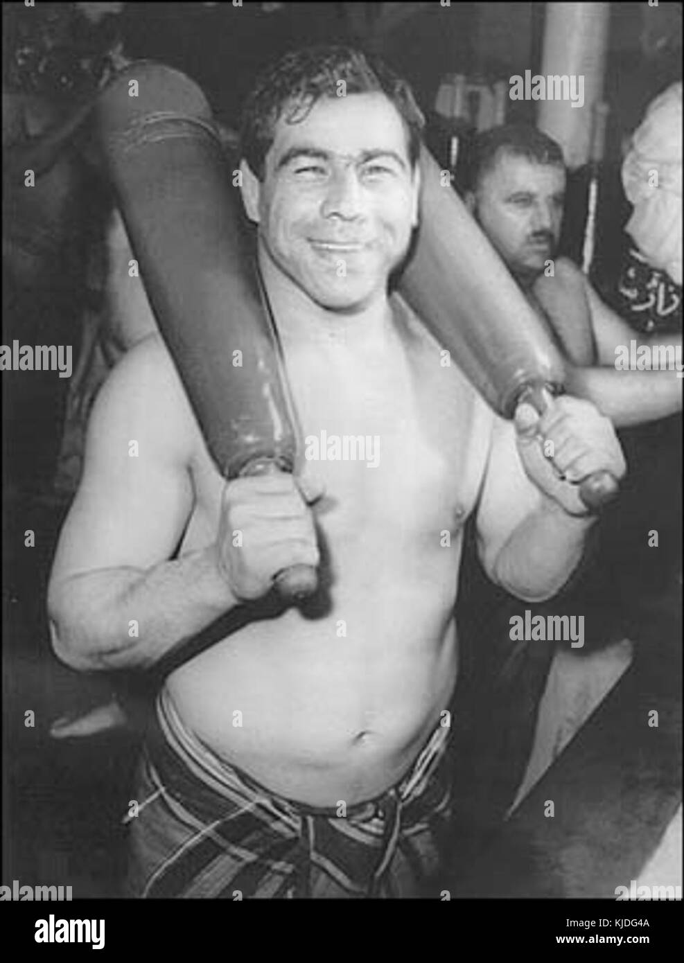 Pahlavan Takhti war ein prominenter iranischer Wrestler, der für seine Leistungen in diesem Sport bekannt war. Der Begriff "meel" bezieht sich auf ein traditionelles iranisches Gewicht, das beim Ringen verwendet wird. Stockfoto
