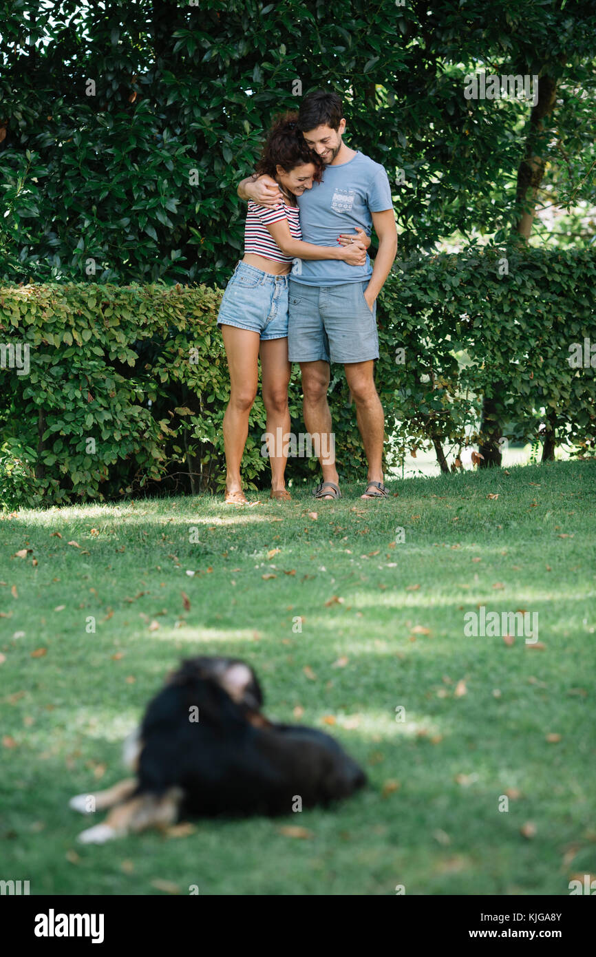 Verliebtes Paar mit Hund in einem Park Stockfoto