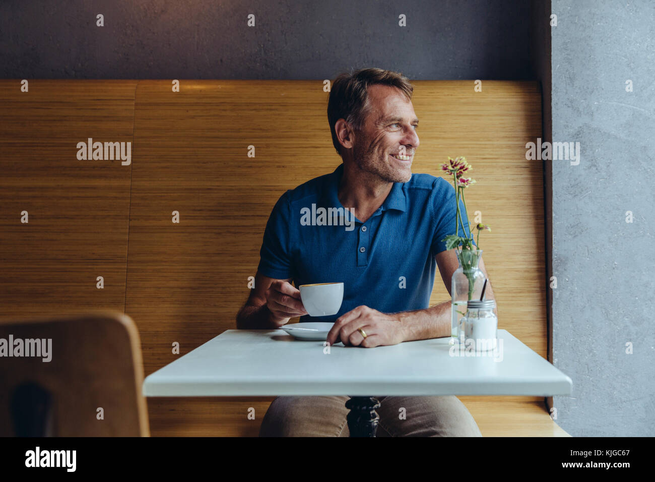 Lächelnd reifer Mann im Cafe sitzen Stockfoto
