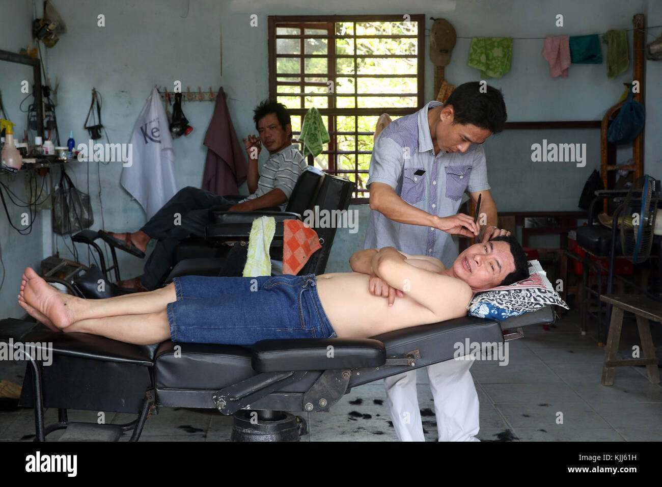 Friseur. Friseur rasieren Kunden. Hoi An. Vietnam. Stockfoto