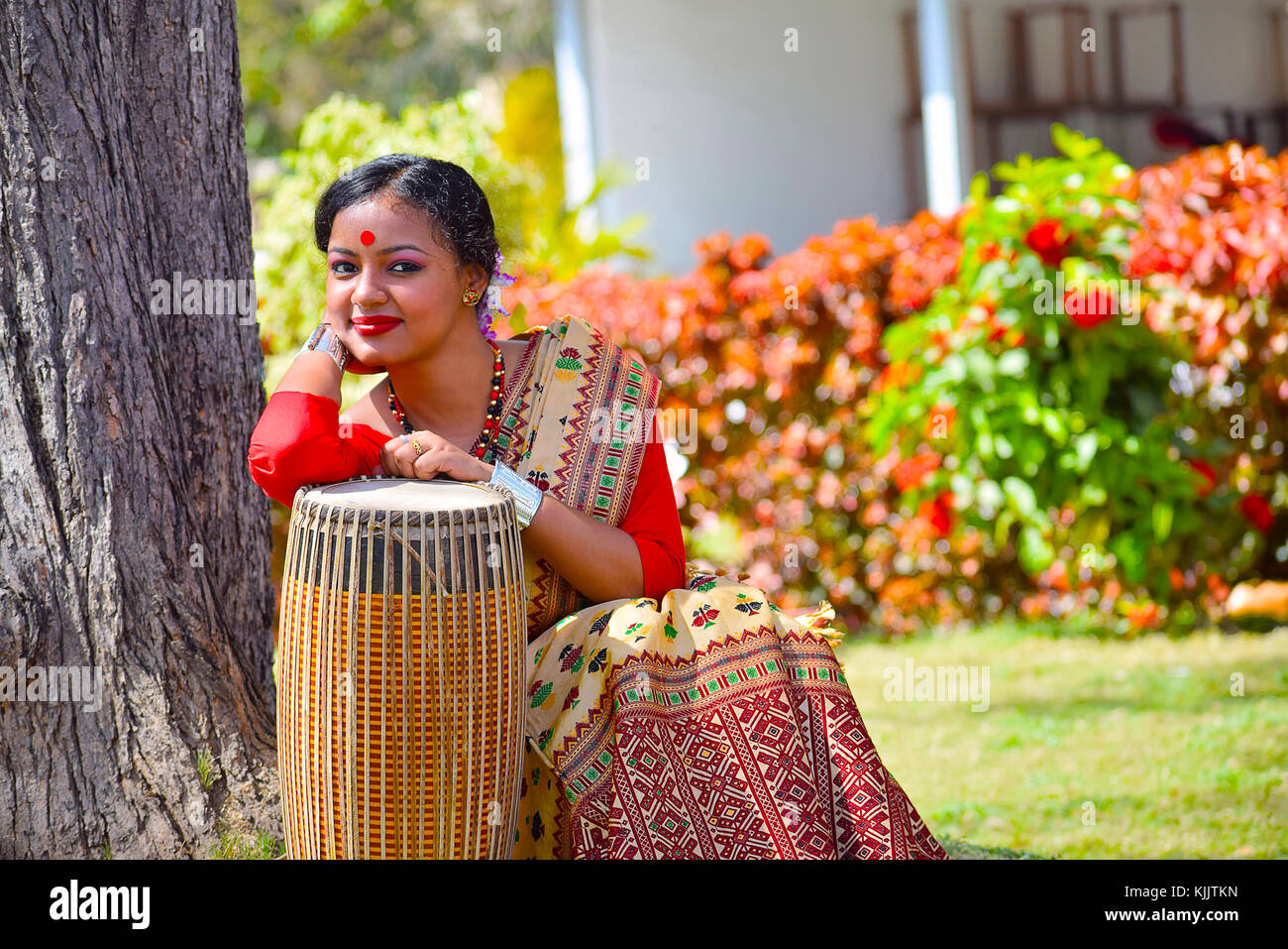 Assamesisch Mädchen in traditioneller Kleidung mit einem Dhol (Trommel), Pune, Maharashtra posieren. Stockfoto