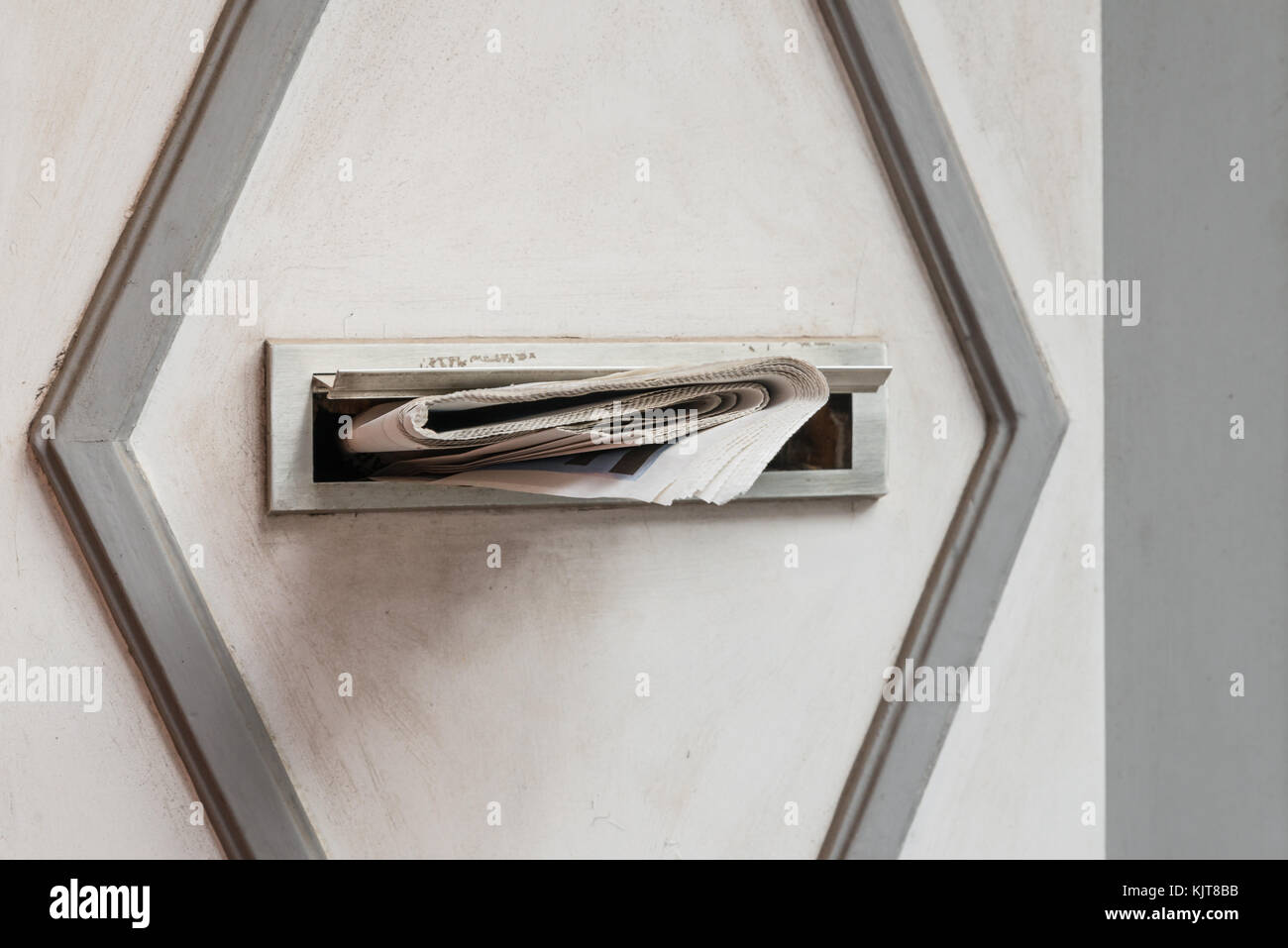 Zeitung in einer Mail Steckplatz Stockfoto