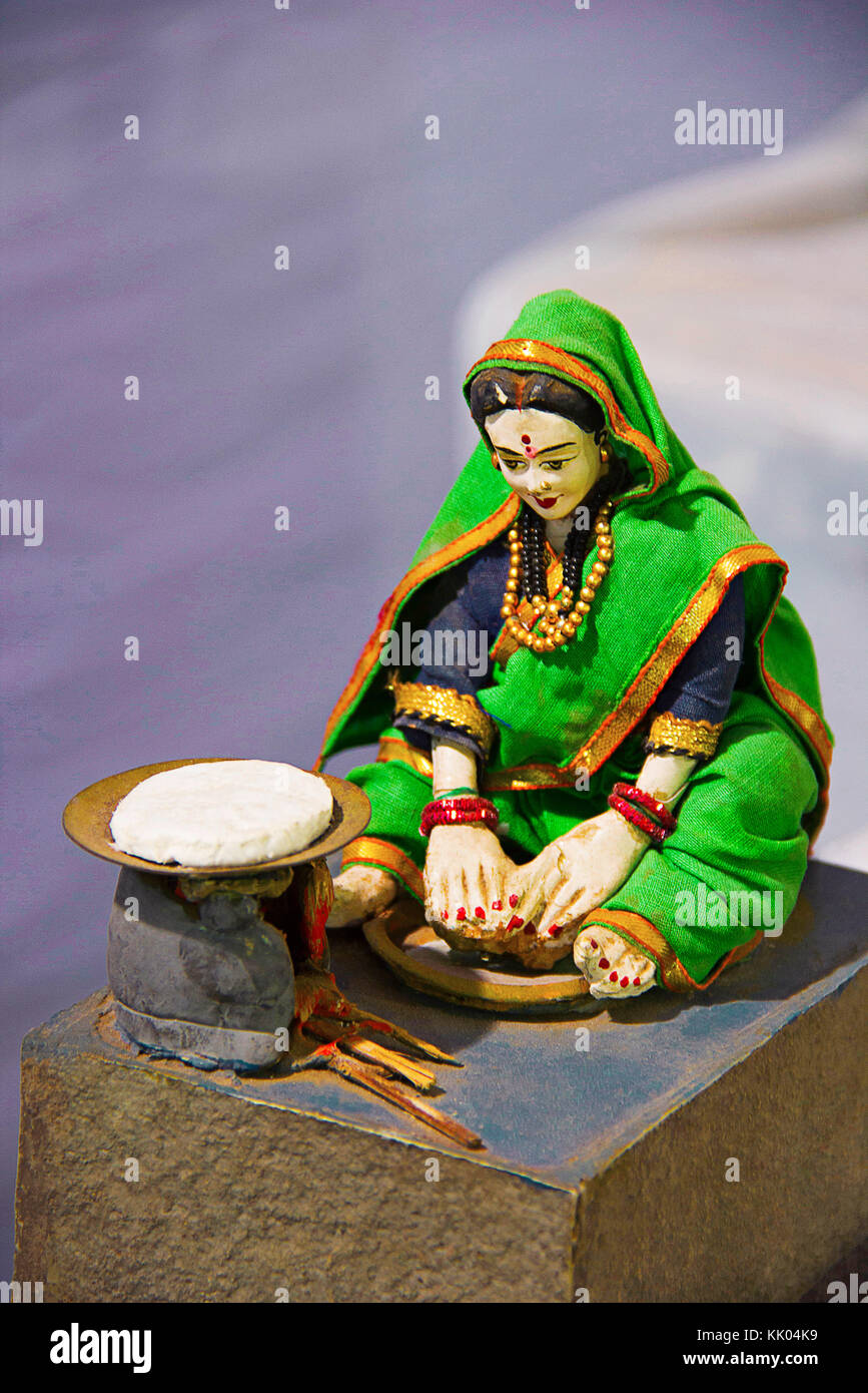Skulptur einer traditionellen Maharashtrian-Frau, die Rotis auf einem traditionellen Ofen oder Chulla macht Stockfoto