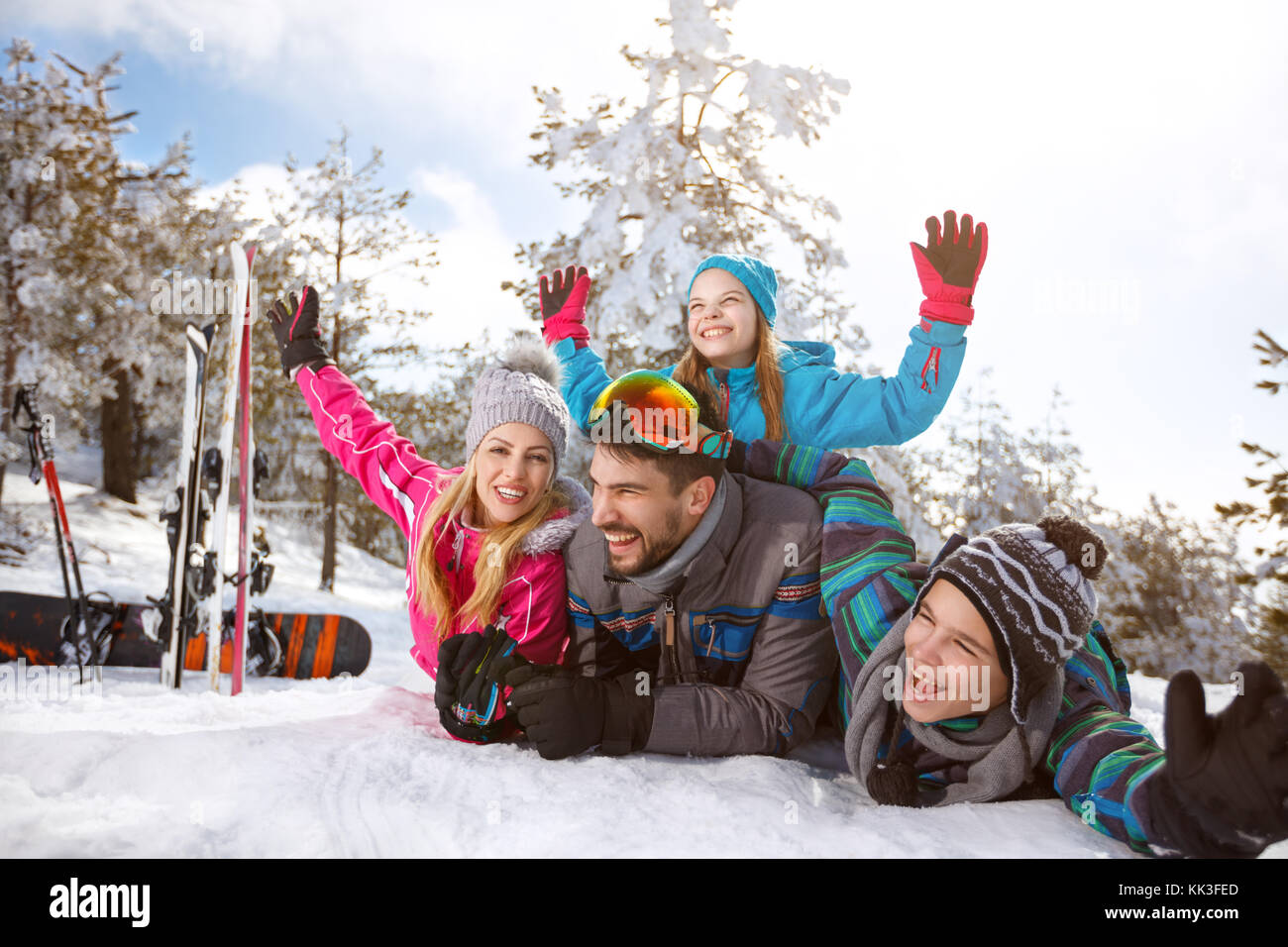 Glückliche junge Familie zusammen auf Schnee im Winter Urlaub Stockfoto