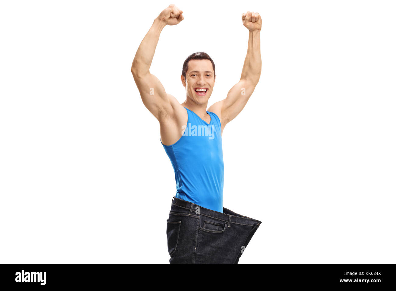 Überglücklich muskulöser Kerl, ein Paar Jeans in Übergröße auf weißem Hintergrund Stockfoto
