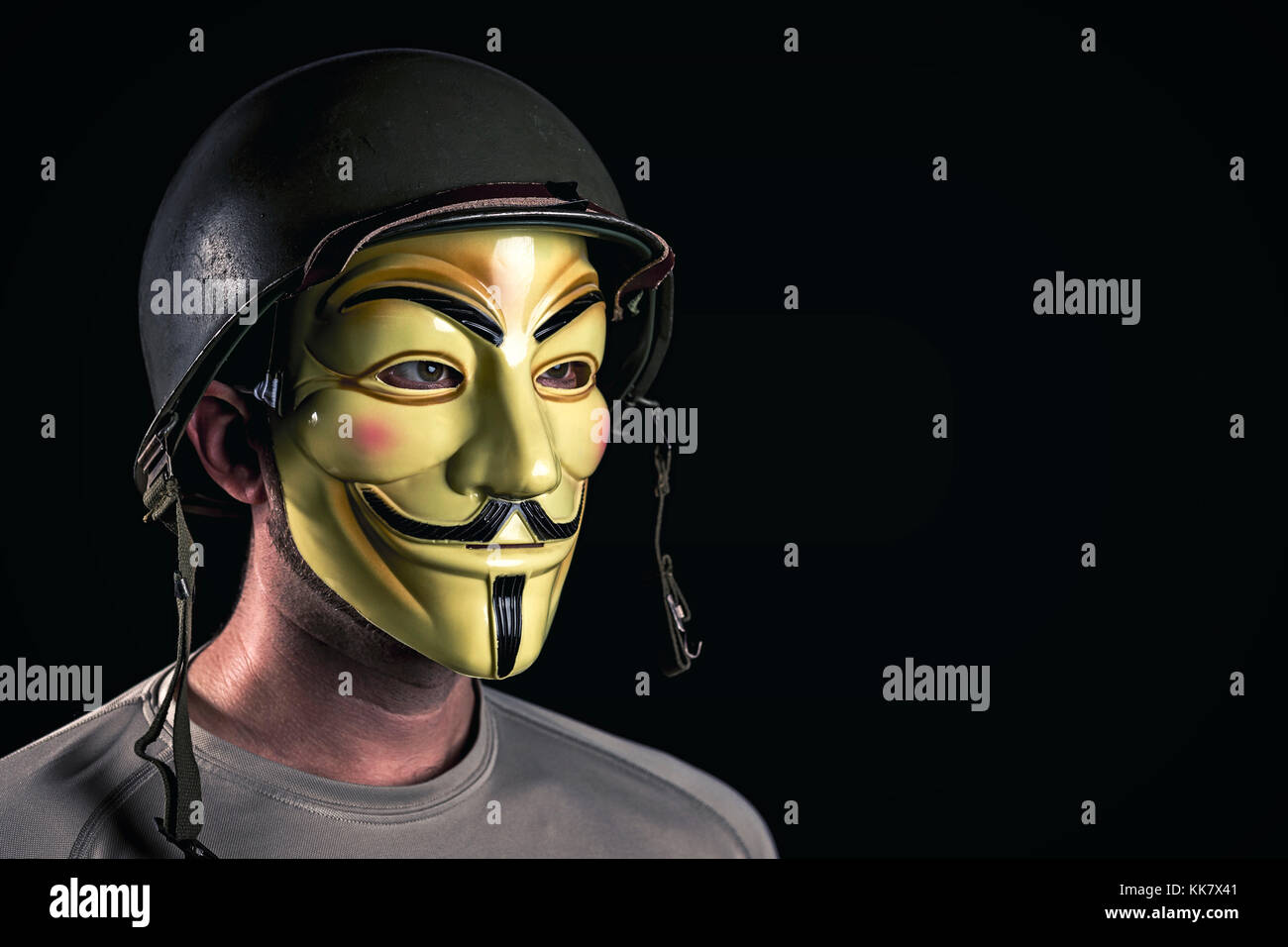 Mailand, Italien, November 2017: Hacker Verschleiß anonymus Maske und usa Armee Helm im Dunkeln. editorial Foto. Stockfoto
