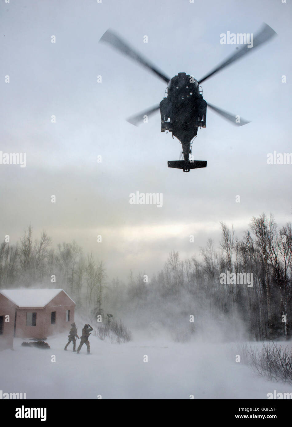 Alaska Air National Guard pararescuemen mit der 212Th Rescue Squadron mit einer eingehenden UH-60 Black Hawk Hubschrauber während einer Messe- und Unfallversicherung Schulungsveranstaltung an Joint Base Elmendorf-Richardson, Alaska, Nov. 21, 2017 kommunizieren. Während der Übung, die Rettung Betreiber befindet, bewertet, behandelt und zahlreiche Opfer evakuiert beim Einkuppeln und die Beseitigung mehrerer Angriffe von oppositionellen Kräften. Die Hubschrauber waren, die von den 1st Bataillon der Alaska Army National Guard, 207 Aviation Regiment. (U.S. Air Force Foto von Alejandro Peña) Stockfoto