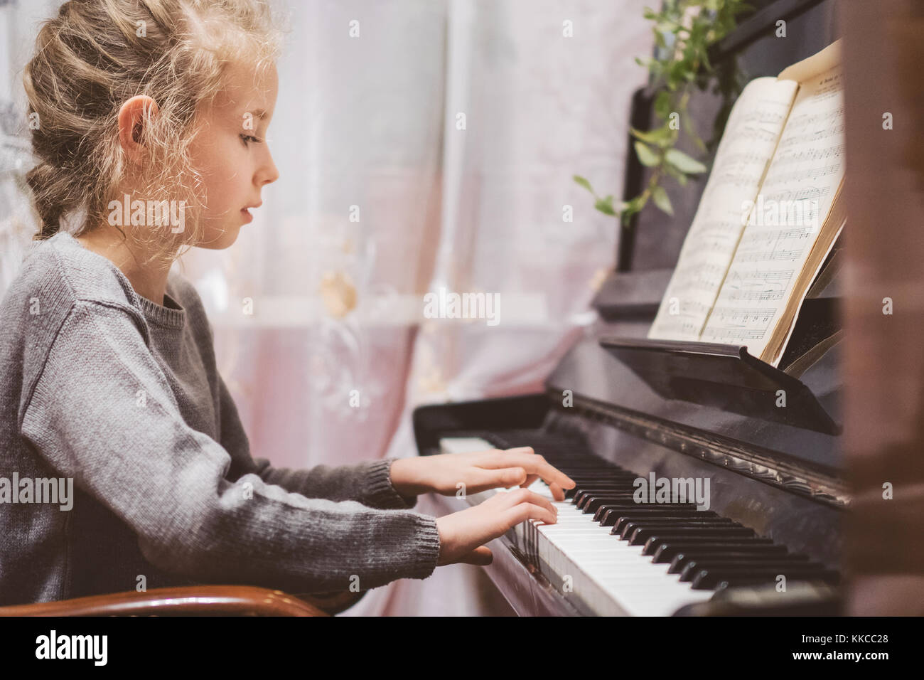 Kleines Mädchen lernen, Klavier zu spielen. Stockfoto