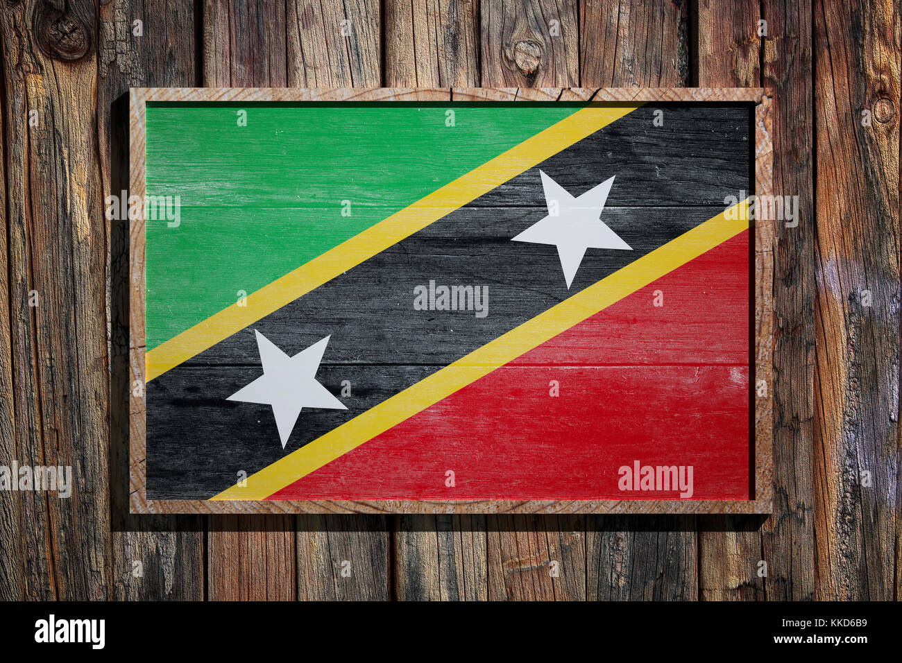 3D-Darstellung der Flagge des Heiligen Christoph und Nevis auf einem Holzrahmen über einer Dielenwand Stockfoto