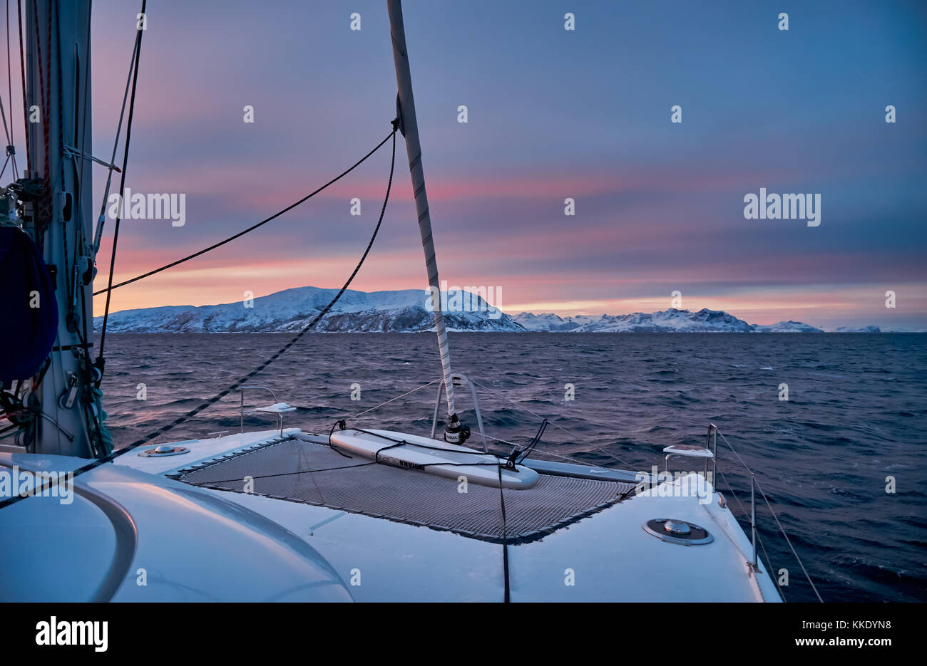 Sonnenaufgang über dem Fjord mit Schnee bedeckte Berge und im Winter Landschaft von sailship in der Nähe von Tromsø, Troms, Norwegen, Europa Stockfoto