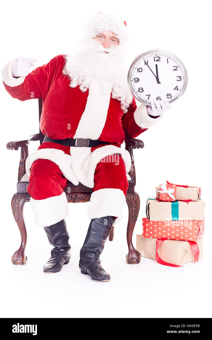 Der Weihnachtsmann hält die Uhr Stockfoto