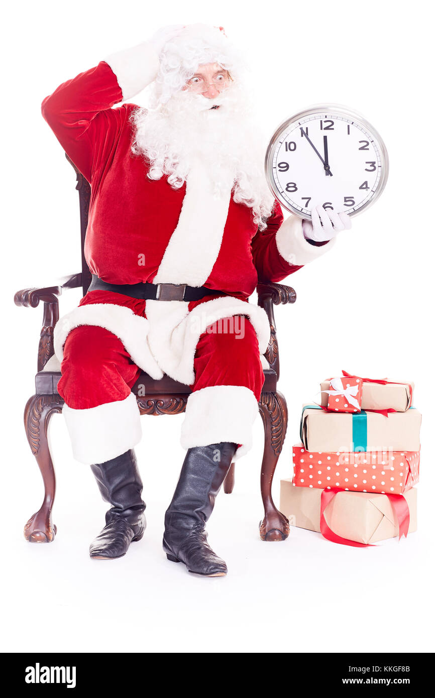 Der Weihnachtsmann hält die Uhr Stockfoto