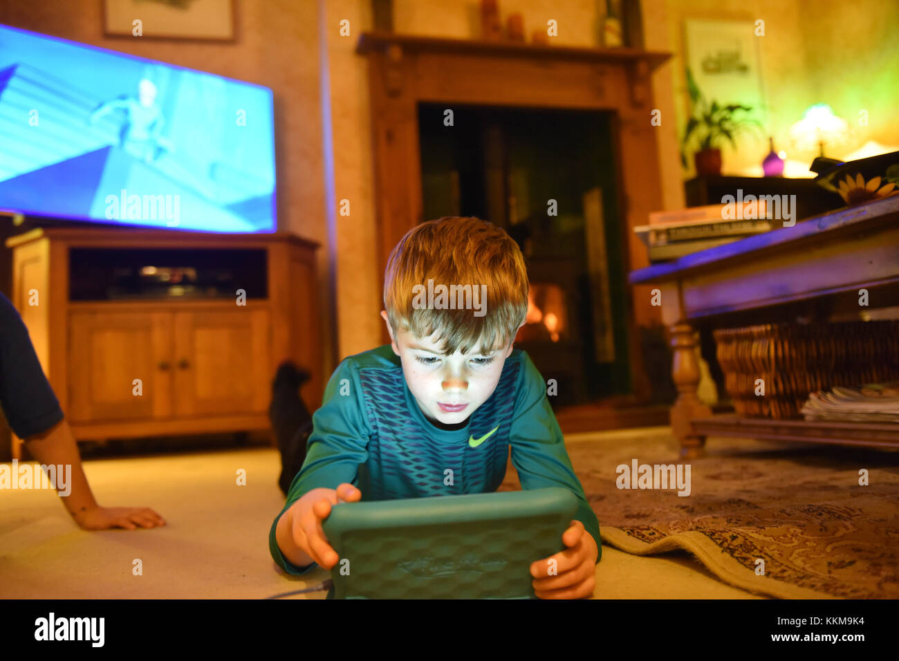 Junge Kind spielen auf Feuer Android tablet Stockfoto