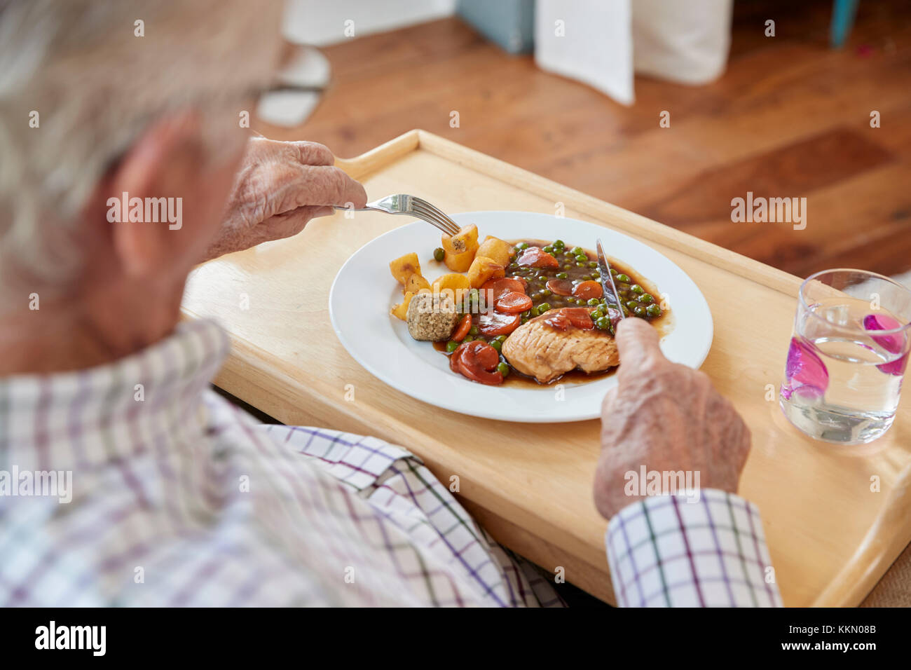 Blick über die Schulter des älteren Menschen essen zu Hause Stockfoto