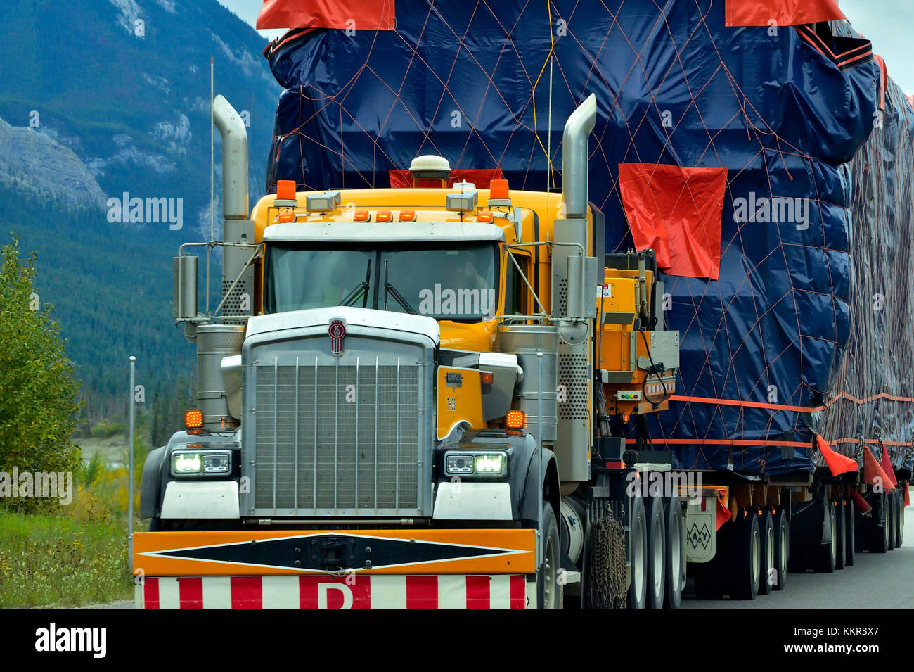 Eine Nahaufnahme von einem Semi Truck mit einer überdimensionalen Last Reisen auf ein Alberta highway Stockfoto