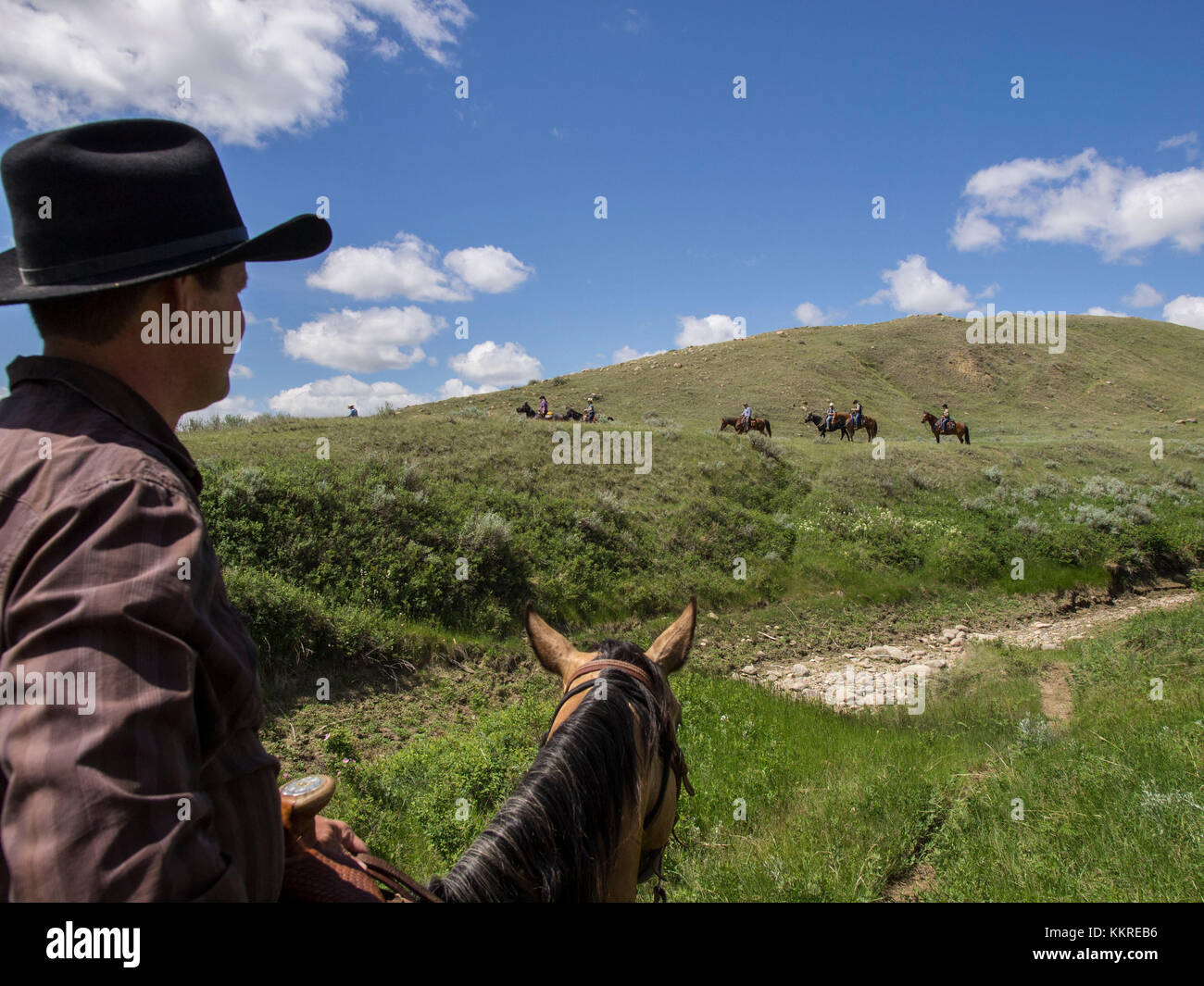Reiter und Ranchgast Jamie Ross (im Vordergrund) Stockfoto
