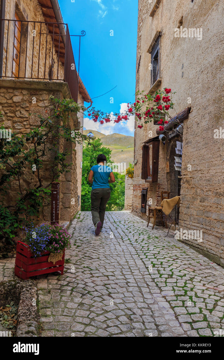 Eine Person führt eine Straße im historischen Zentrum von Santo Stefano di Sessanio, Abruzzen, Italien. Stockfoto