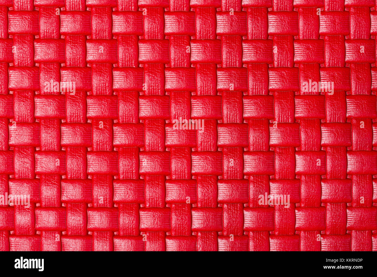 Helles Rot geflochtenem Leder Textur. Stockfoto