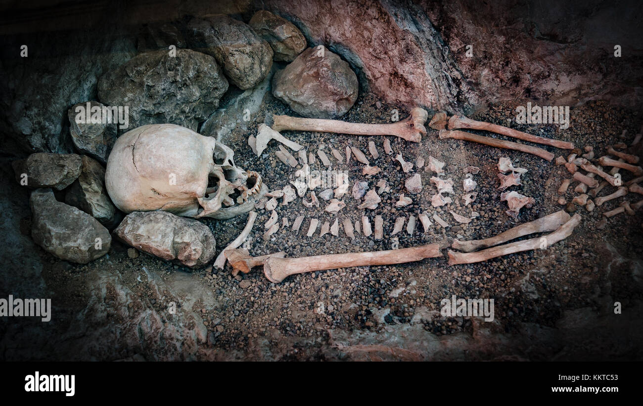 Schädel und Knochen von einer primitiven Menschen in einer Höhle. Stockfoto