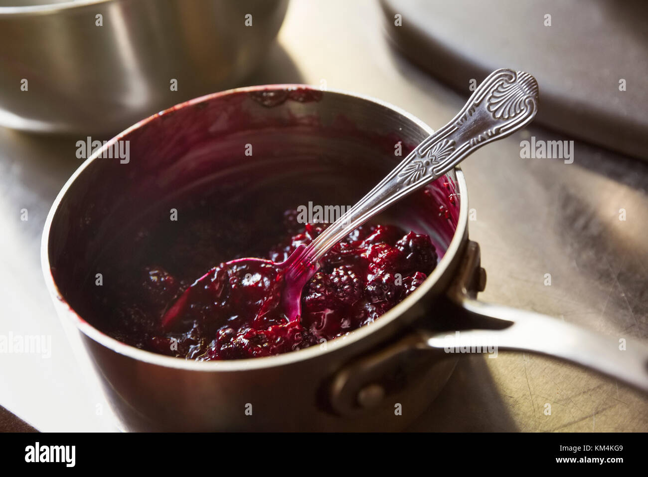 Hohe Betrachtungswinkel von Rote Grütze in eine Kasserolle mit einem silbernen Löffel. Stockfoto