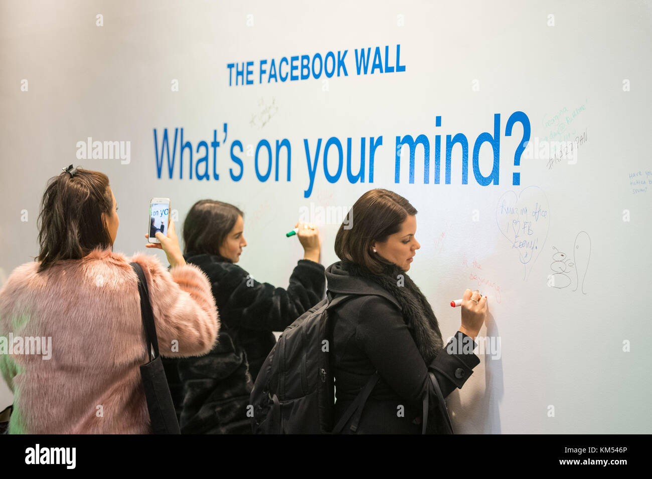 Mitarbeiter schreiben Botschaften an die Wand an der New Facebook Frank Gehry entworfene Hauptsitz am Rathbone in London. Stockfoto