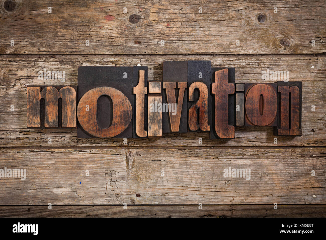 Motivation, einzelnes Wort mit Vintage Buchdruck Blöcke auf rustikalen Holzmöbeln Hintergrund Stockfoto
