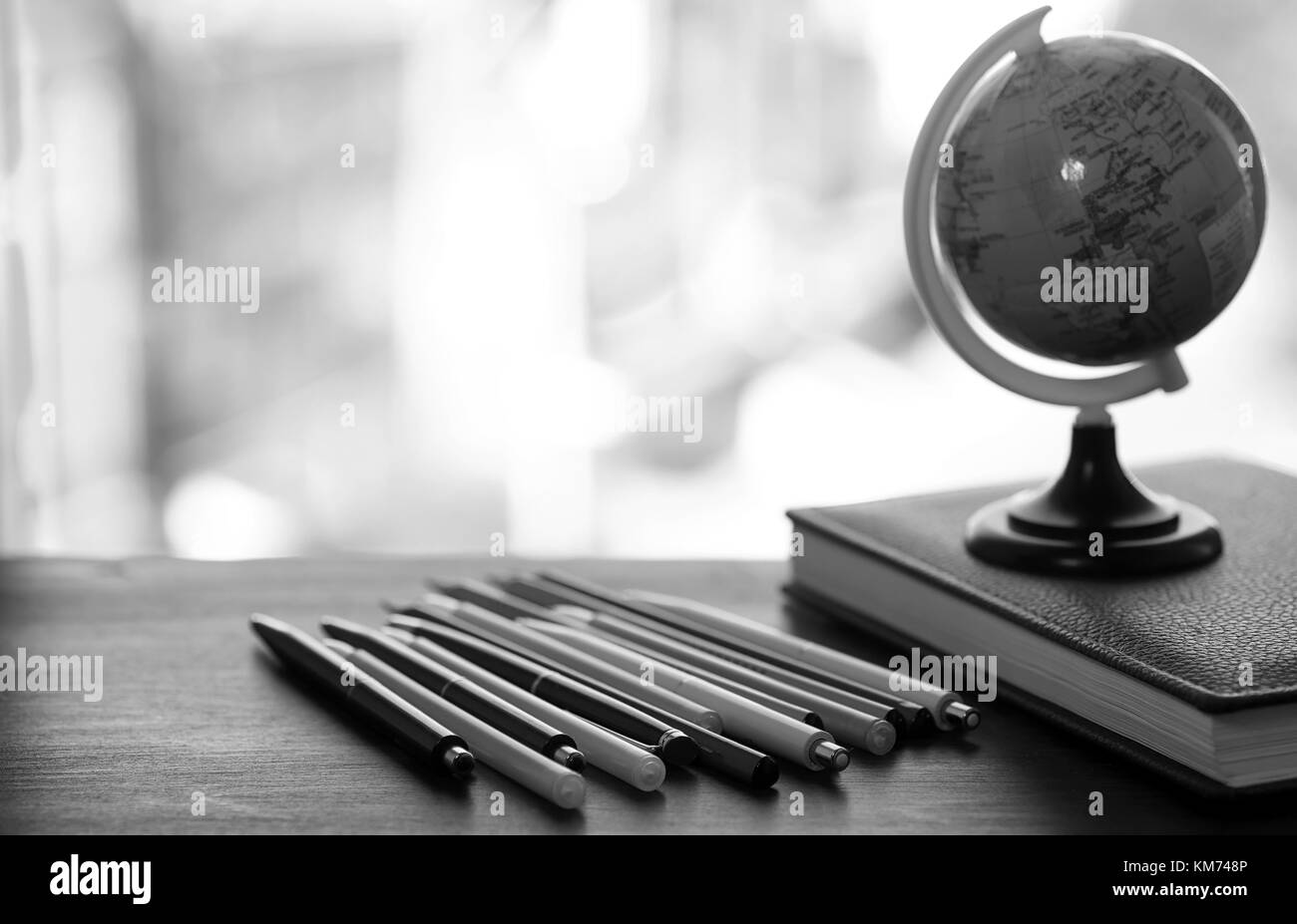 Ein Stift auf dem Schreibtisch mit kleinen Globus Stockfoto