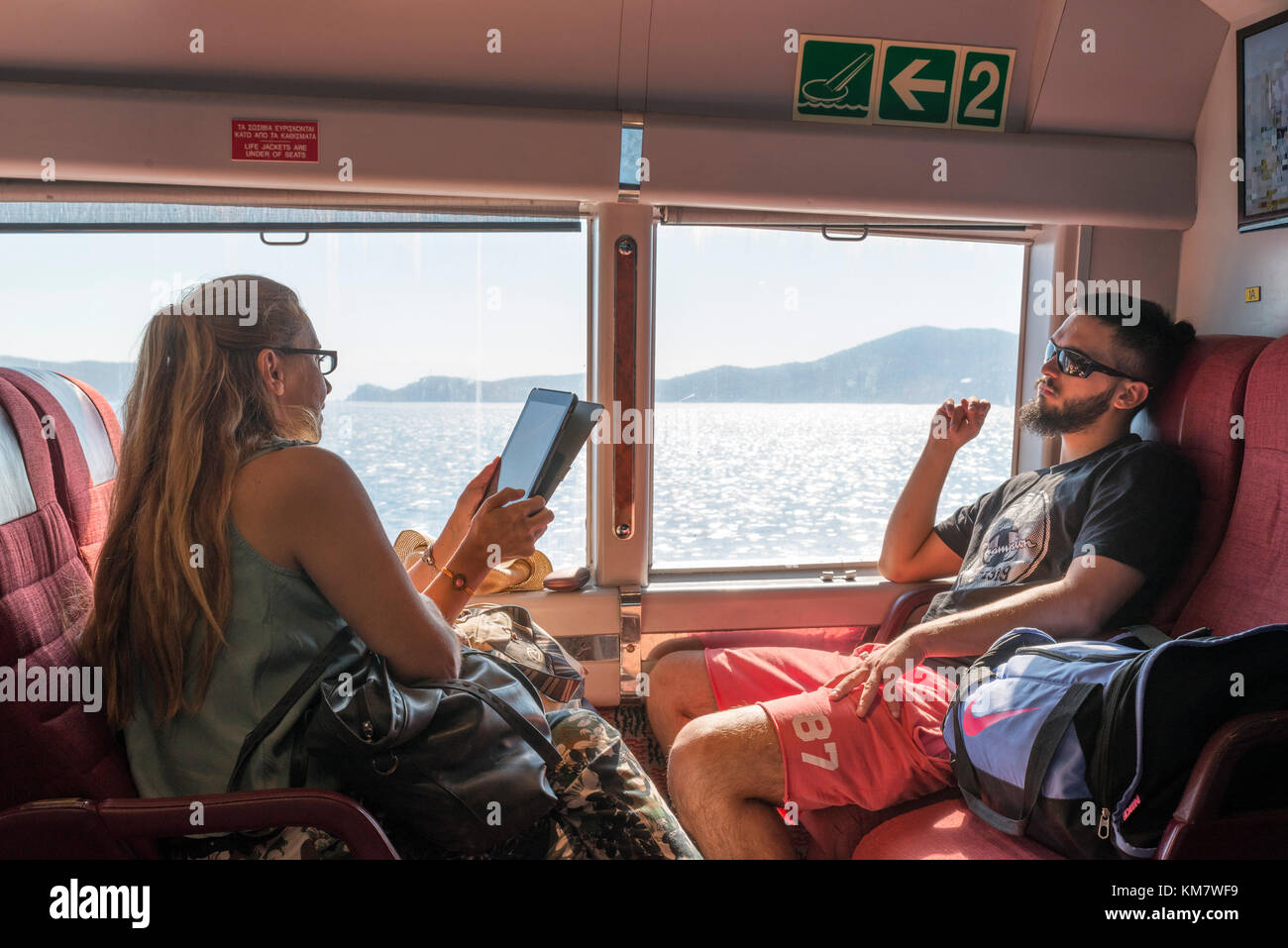 Die Passagiere auf den Hellenic Seaways FlyingCat Schnellfähre zwischen Piräus und Hydra, griechische Inseln, Griechenland Stockfoto