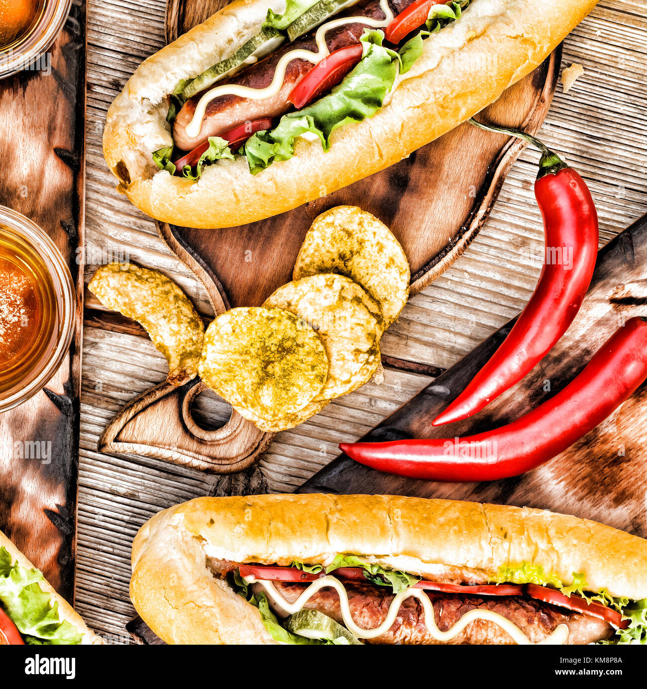 Hot Dogs, Bier, Chips auf hölzernen Tisch in der Kneipe. Stockfoto