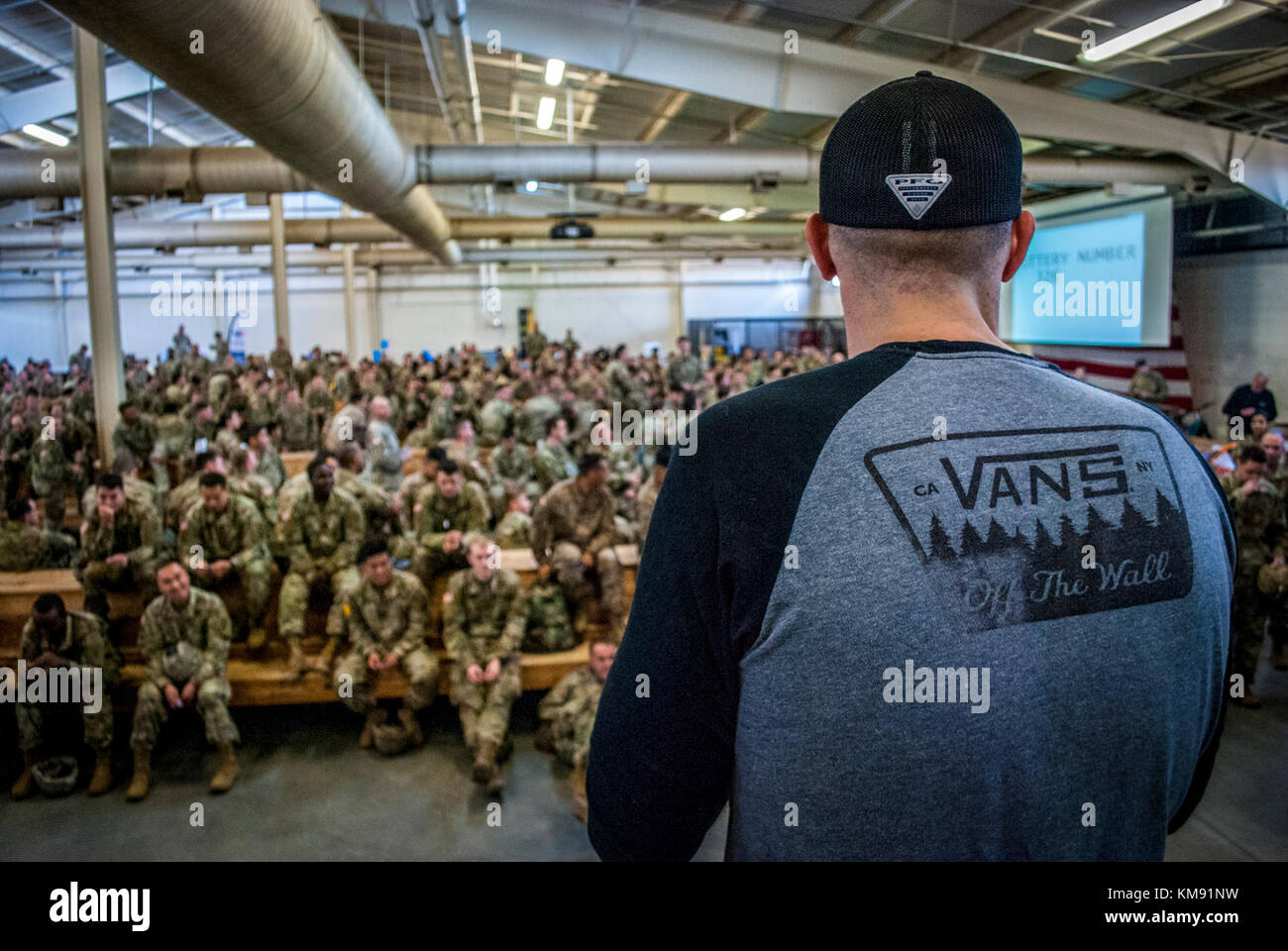 Zach Oler, Sohn von Sgt. 1. Klasse Randy Oler, liest Lottery ticket Zahlen vor einer Masse von eifrig Fallschirmjäger bei der 20. jährlichen Randy Oler Memorial Betrieb Spielzeug Fallen, Dez. 1, 2017 in der Green Ramp Passenger Terminal in Fort Bragg, North Carolina. Dann gegründet - Staff Sgt. Klasse Randy Oler in 1998, Betrieb Spielzeug Drop ist eine jährliche Airborne Operation, die im Jump Meister bringt Partner aus mehreren Nationen US-Fallschirmjäger zu trainieren und als Weg zurück in die Gemeinschaft und helfen Kindern in Not durch gespendete Spielzeug geben. Oler verstarb im Jahr 2004 während der Durchführung springen Mast Stockfoto