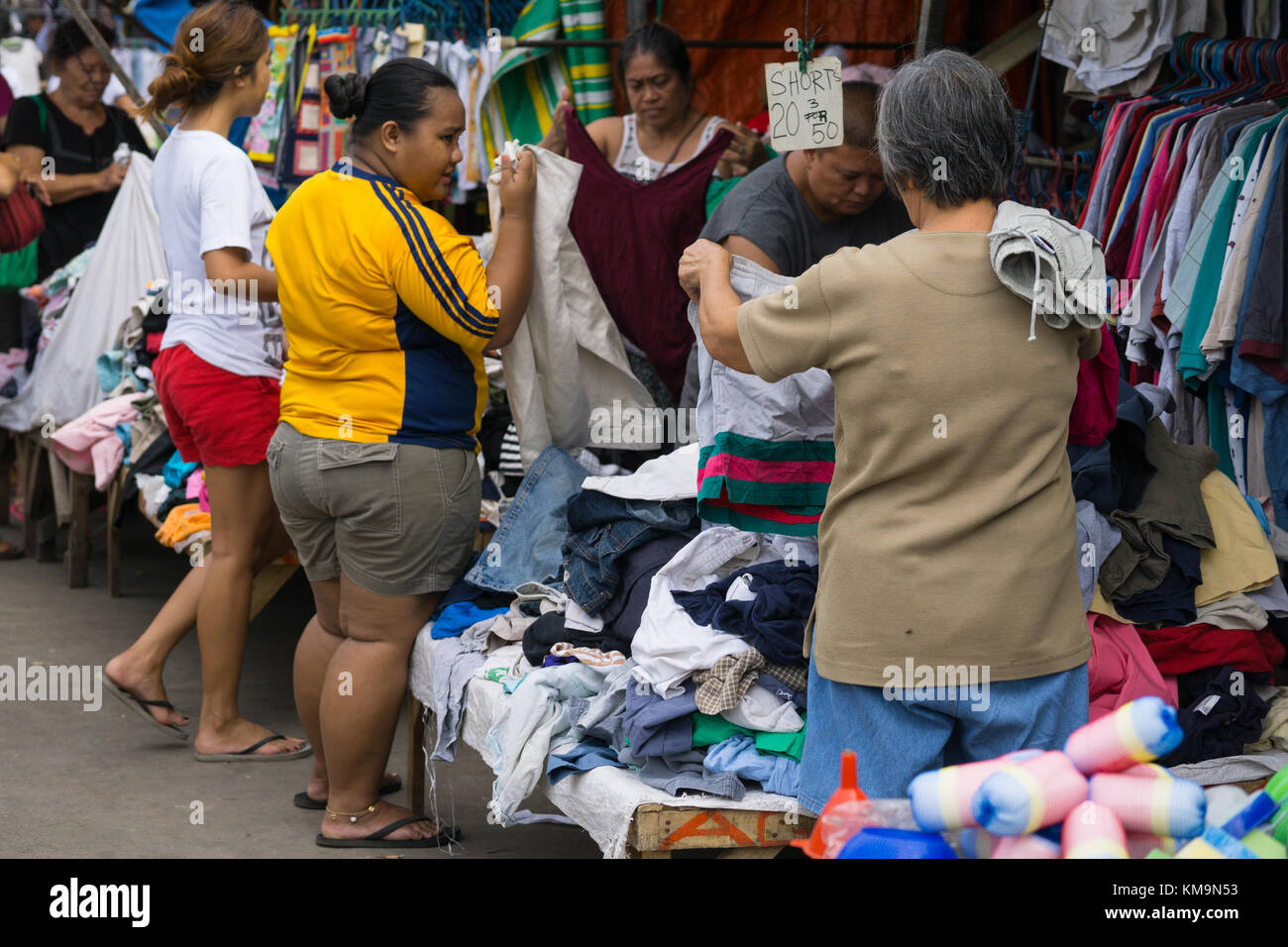 Philippinische Frauen kaufen in einem gebrauchten Bekleidungsgeschäft ein, das als Ukay-Ukay-Geschäft, Cebu City, Philippinen, bekannt ist Stockfoto