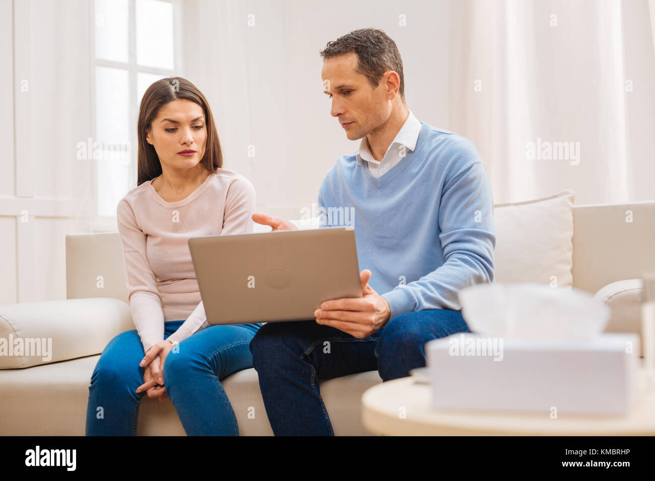 Angenehme smart Mann zeigt neue Haus zu Frau auf Laptop Stockfoto