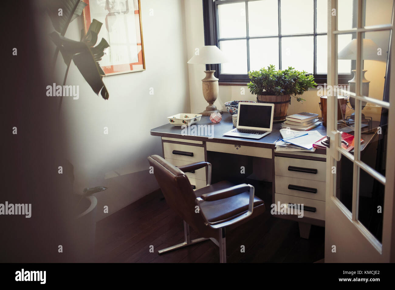 Laptop und Schreibarbeit auf dem Schreibtisch im Heimbüro Stockfoto