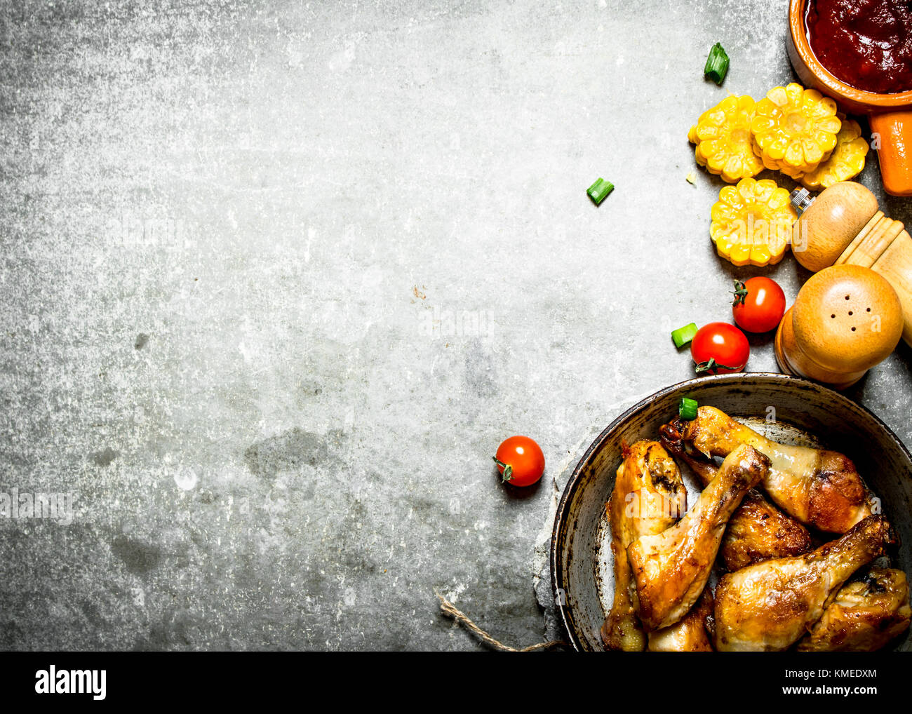 Gebratenes Huhn mit Gemüse und Tomatensauce. Auf einem Stein. Stockfoto