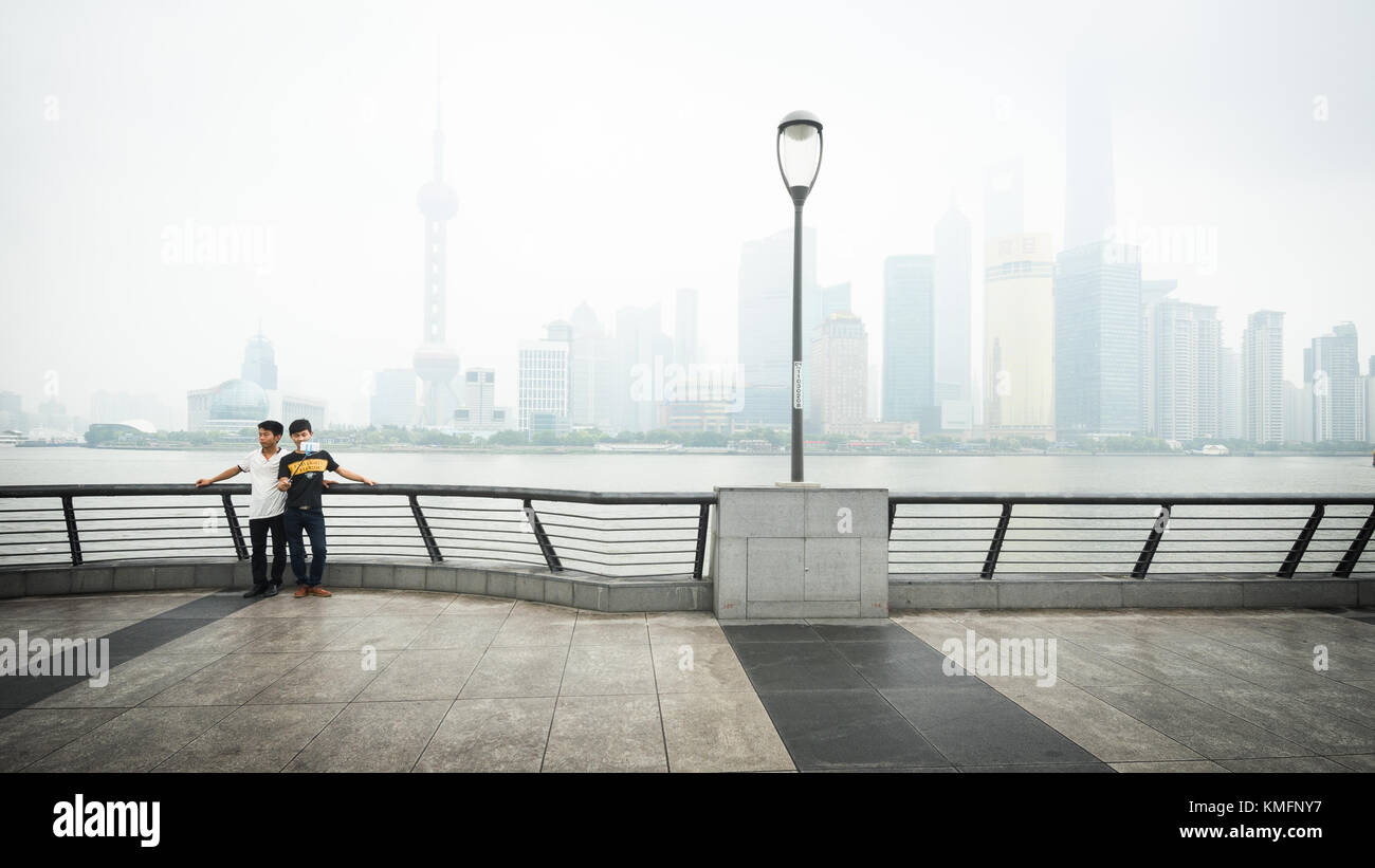 SHANGHAI, China - 6 Jun 2015: Zwei junge Männer posieren für ein selfie Bild vor der Skyline Shanghais Geschäftsviertel. Aus über dem Fluss Huangpu Stockfoto